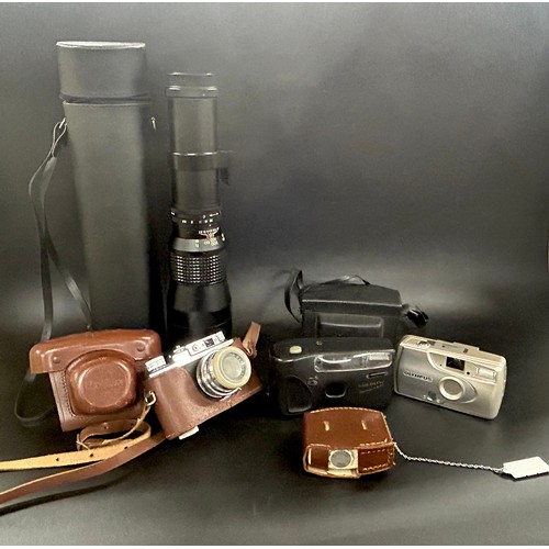 2152 - A collection of cameras and a long lens, to include compact cameras and an SLR and light meter