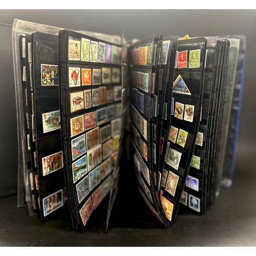 2153 - An album of 20th Century world stamps, to include Canada, Australia, Guernsey, Netherlands, India, I... 