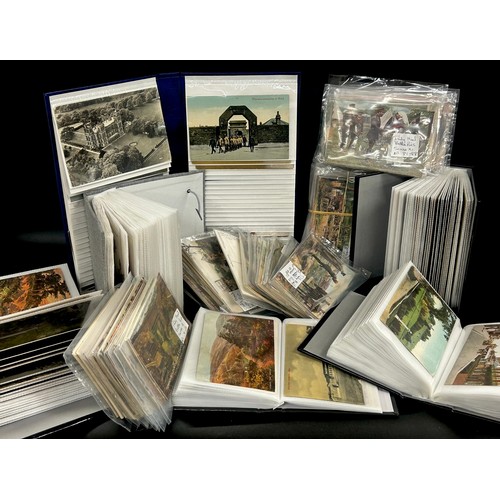 2136 - A large collection of topographical British postcards, an album of British Army Regiments and Unifor... 