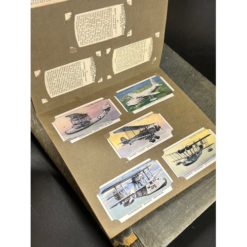 2170 - A collection of 20th Century British and foreign stamps in albums and a collection of cigarette card... 
