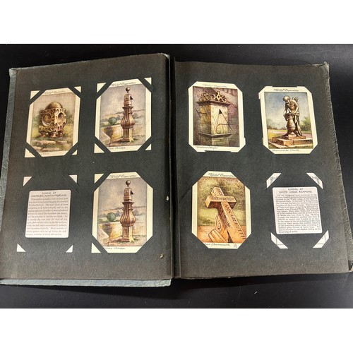 2170 - A collection of 20th Century British and foreign stamps in albums and a collection of cigarette card... 
