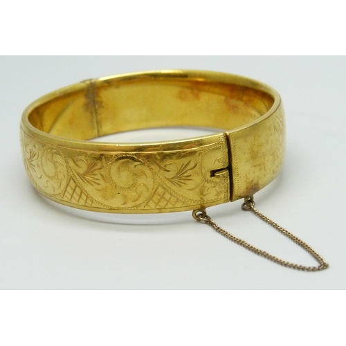 7016 - A 9ct gold metal cored bangle, 20 microns, 30g, 6.2 x 5.5cm