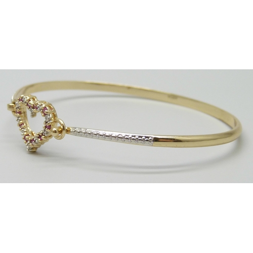 7019 - A silver gilt heart design bangle set with rubies, 8g, 6.4 x 5cm