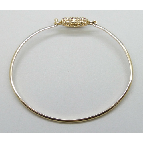 7019 - A silver gilt heart design bangle set with rubies, 8g, 6.4 x 5cm