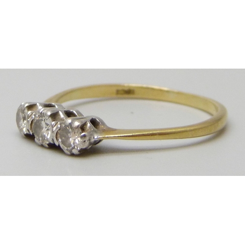 7028 - An 18ct gold three stone diamond ring, 1.7g, N