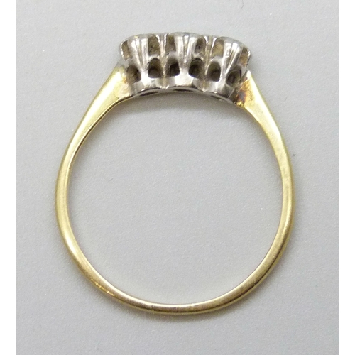 7028 - An 18ct gold three stone diamond ring, 1.7g, N