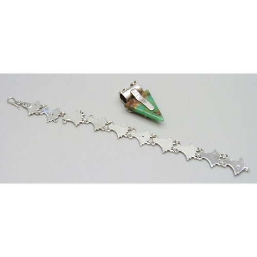 7031 - A possibly Egyptian white metal bracelet with control marks, a/f, and a silver mounted pendant, 24g ... 