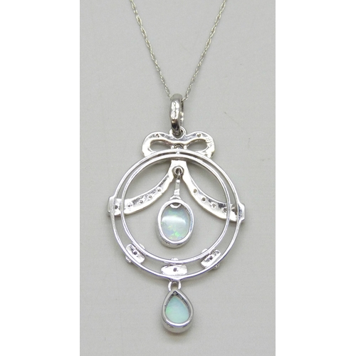 7035 - A 9ct white gold, diamond and opal pendant on a 10k white gold chain, 3.5g, 3.9cm including bail