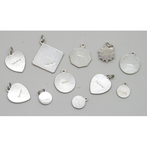 7036 - A collection of silver St Christopher pendants and charms, and a white metal flower pendant, 12.8g