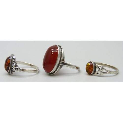 7043 - Two silver rings and a white metal ring, 9.8g