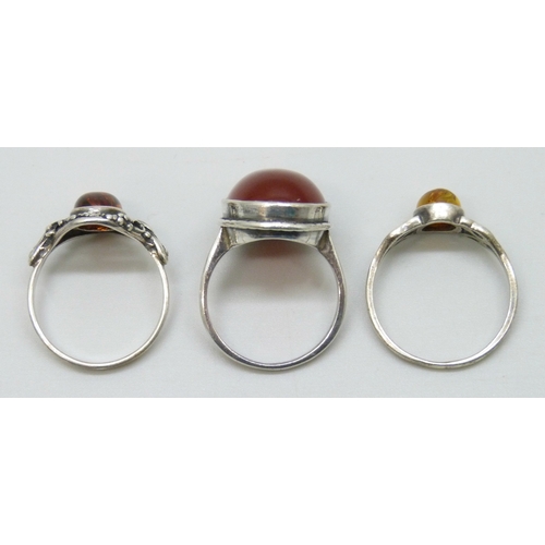 7043 - Two silver rings and a white metal ring, 9.8g