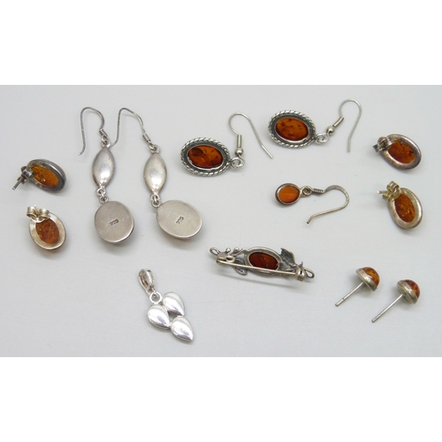 7058 - A collection of silver and white metal amber set jewellery, 21g