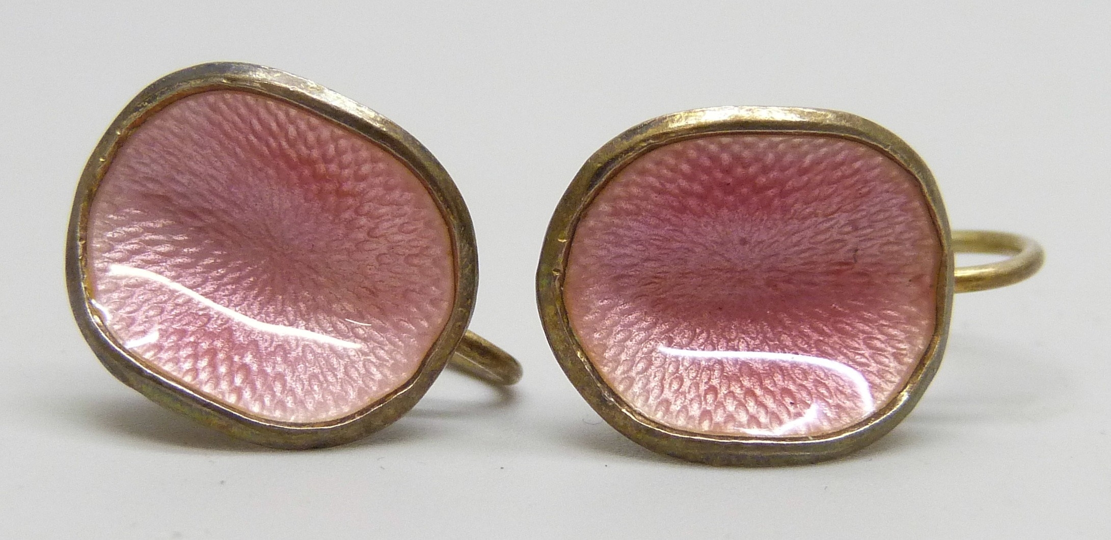 A pair of Ivar Holth Norwegian silver gilt and pink guilloche enamel ...