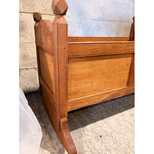 A wooden rocking cot