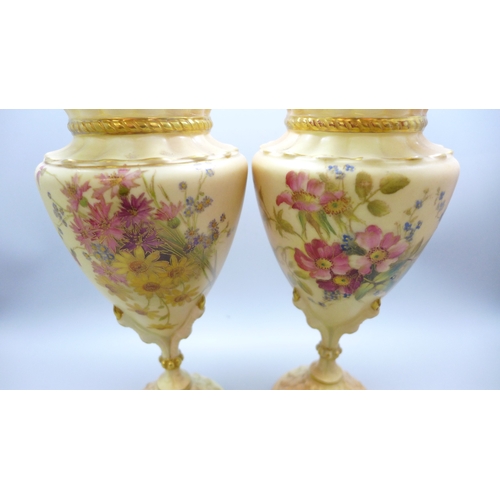 2007 - A pair of 2314 Royal Worcester Blush Ivory vases, 1906, (one a/f, chip on the rim), 20cm