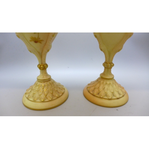2007 - A pair of 2314 Royal Worcester Blush Ivory vases, 1906, (one a/f, chip on the rim), 20cm