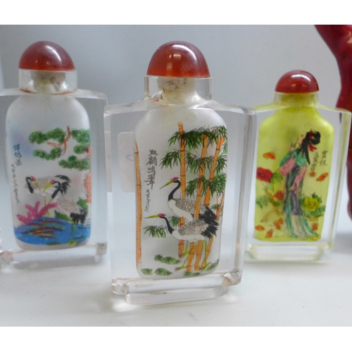 2041 - Four oriental snuff bottles, a carved alabaster figure and a coral piece