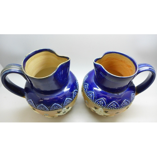 2048 - A pair of Royal Doulton stoneware jugs, stamped 1581, 13cm