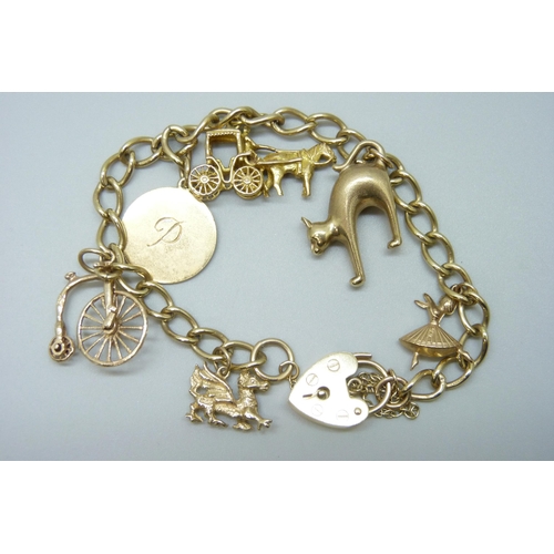 7001 - A 9ct gold bracelet with five 9ct gold charms and a yellow metal 'P' charm, 22.5g