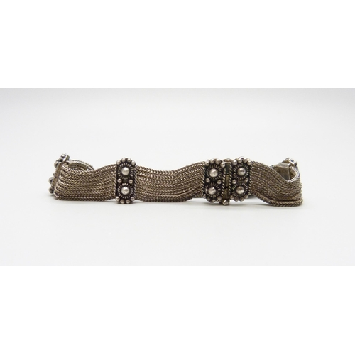 7078 - An Eastern silver bracelet, 26g, and a metal bangle
