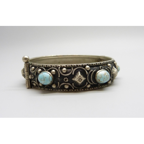 7078 - An Eastern silver bracelet, 26g, and a metal bangle