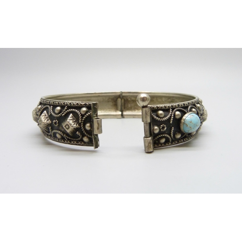 7078 - An Eastern silver bracelet, 26g, and a metal bangle