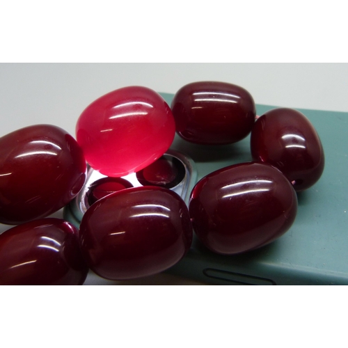 7079 - A very large cherry amber coloured bead necklace, largest bead approximately 4cm, 198g, 53cm