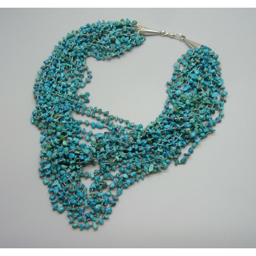 7080 - A statement large seventeen strand turquoise necklace with a silver clasp, 175g, shortest strand 47c... 