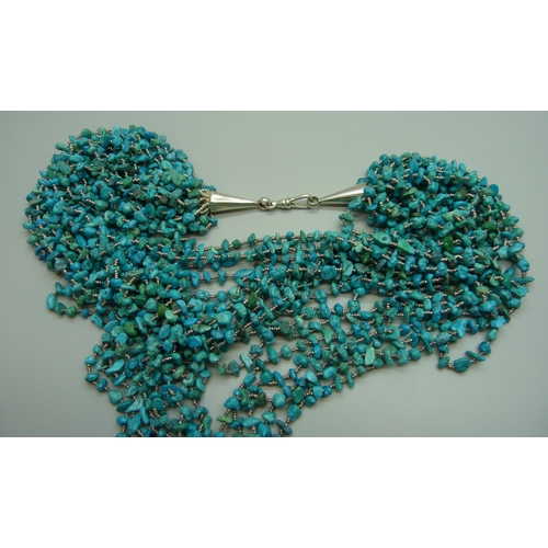 7080 - A statement large seventeen strand turquoise necklace with a silver clasp, 175g, shortest strand 47c... 