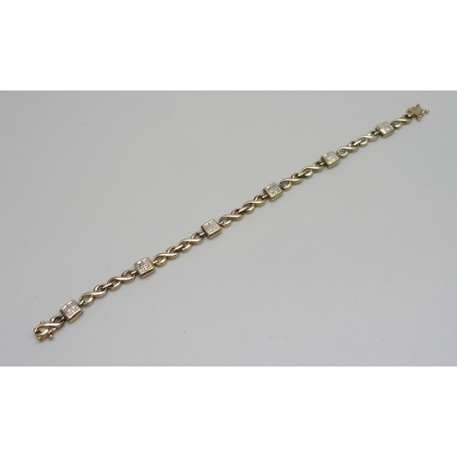 7088 - A 9ct gold and diamond bracelet, 10.7g, 18.3cm, boxed
