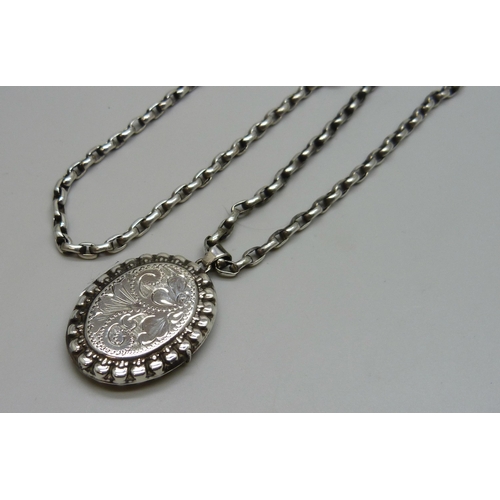 7104 - A Victorian style silver locket, 4.2cm including bail, on a silver long guard chain, 28g total, 73.5... 