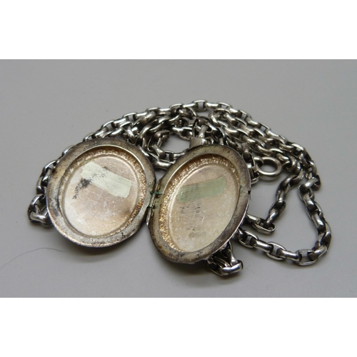 7104 - A Victorian style silver locket, 4.2cm including bail, on a silver long guard chain, 28g total, 73.5... 