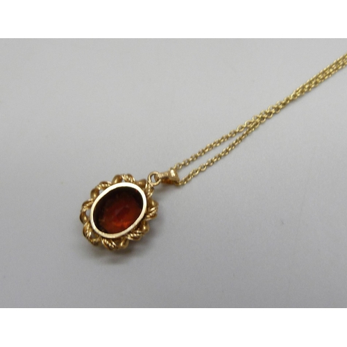7105 - A 14k gold and garnet pendant, 2cm including bail, on a 9ct chain, 40.5cm, 3g total