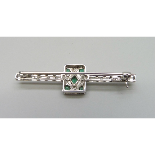 7106 - An Art Deco platinum set emerald and diamond brooch, 6.1g, 5cm, boxed