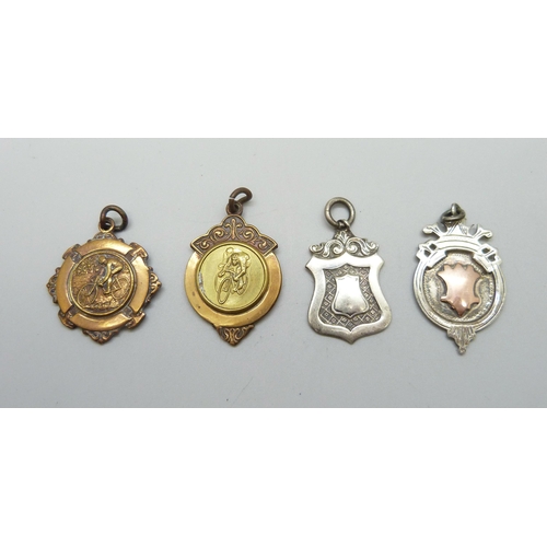 7110 - A silver fob with applied yellow metal plaque, another silver fob,11g, and two metal fobs