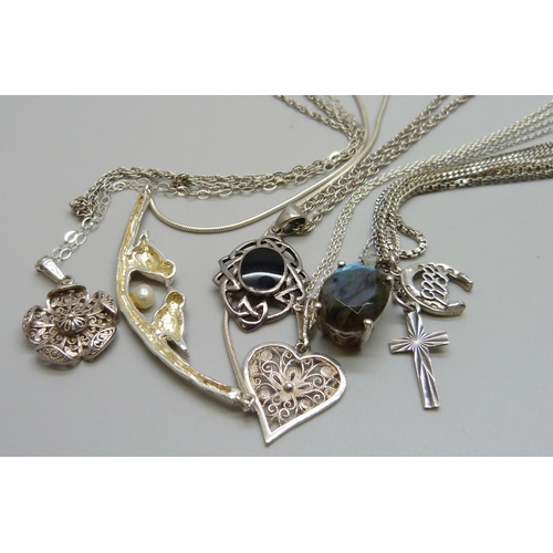 7113 - A collection of silver and white metal pendants with chains incluidng a Kit Heath pendant, 43g
