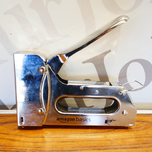 6040 - A box of miscellaneous items to include staple gun, Deltor ear muffs, door stop, wood repair kit, et... 