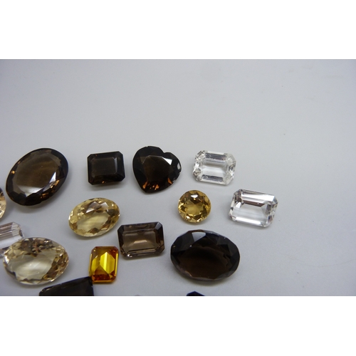 A collection of unmounted stones including citrine and smoky quartz ...