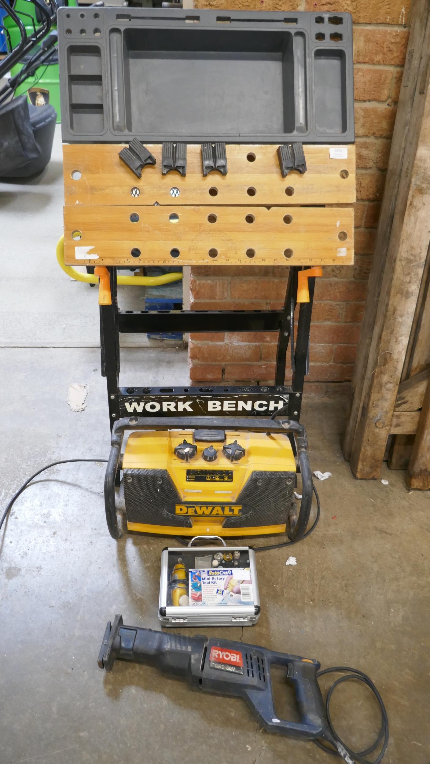 A Workmate modified with a tray, a DeWalt 240V site radio a Rotacraft ...