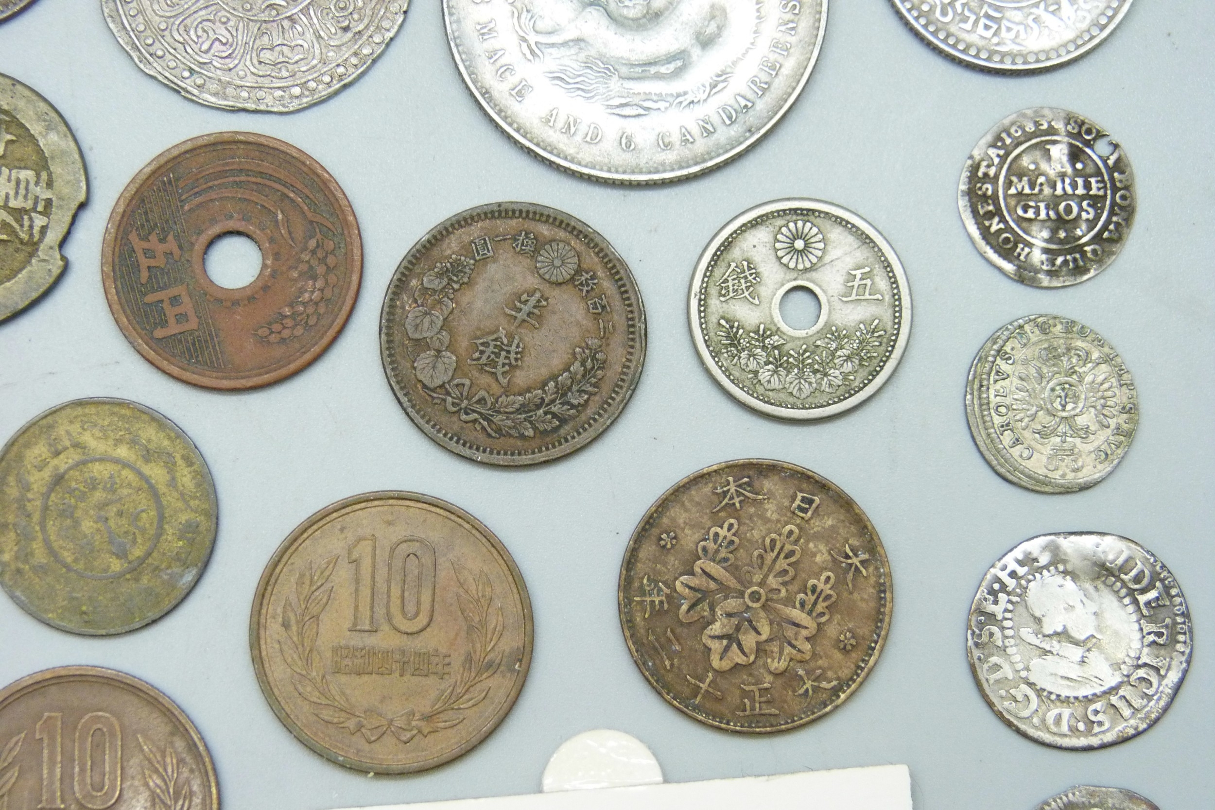 A collection of coins including silver and replica examples