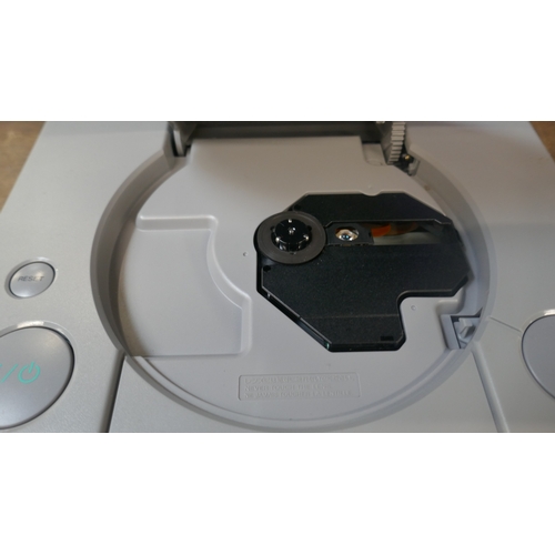 A PlayStation games console with two controllers and power cable in a ...