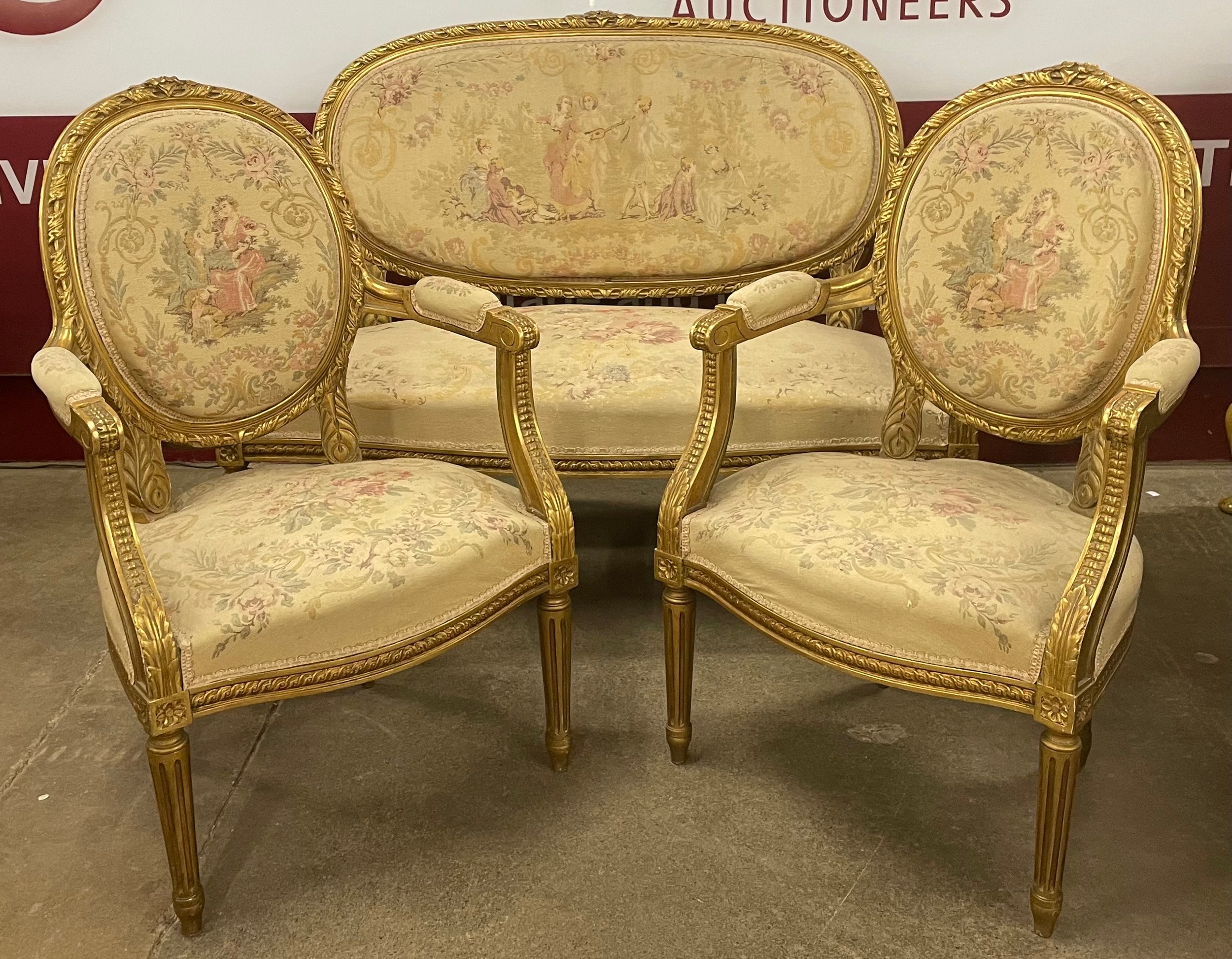 A French Louis XV giltwood and fabric upholstered three piece salon ...