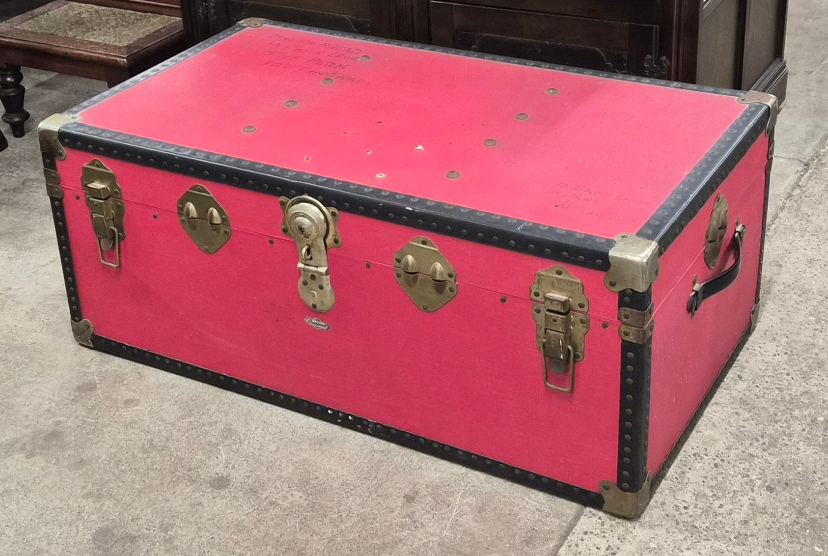 A vintage red steamer trunk