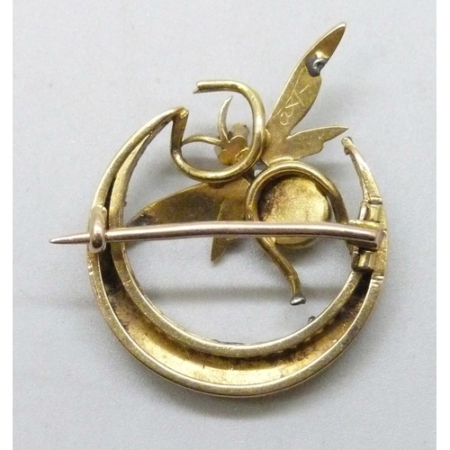 7001 - An early 20th Century yellow metal crescent brooch with insect detail, with seed pearls, diamond and... 