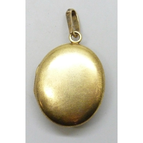7002 - An early 20th Century yellow metal locket set with opals, emerald and small diamonds, 15.6g, 27mm wi... 