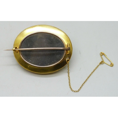 7004 - A large circa 1900 yellow metal and cabochon garnet set brooch with pearl detail, 18.2g, 35mm x 43mm