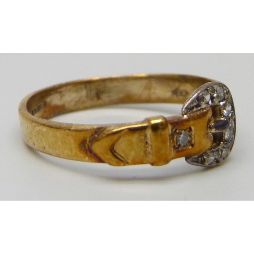 7030 - A 9ct gold buckle ring set with diamonds, 1.8g, M