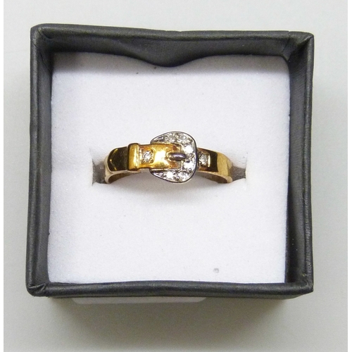 7030 - A 9ct gold buckle ring set with diamonds, 1.8g, M