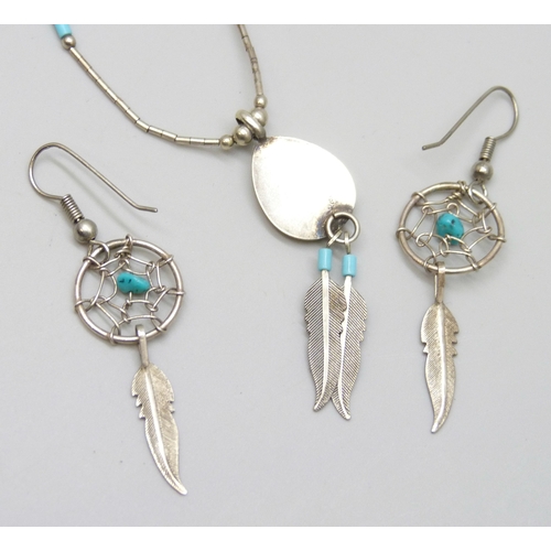 7036 - A white metal necklace and a pair of similar earrings