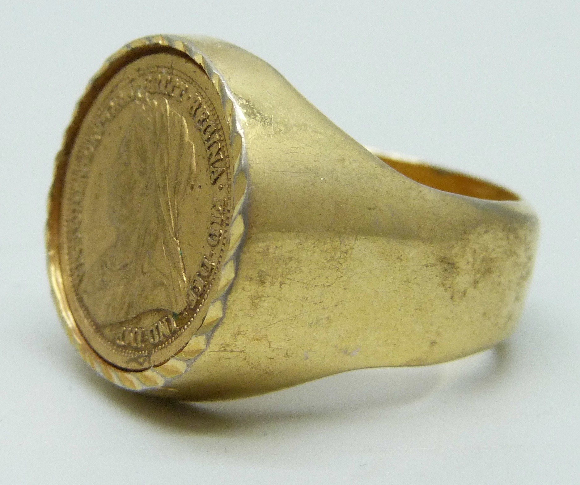 A large gilt coin ring, tests as silver, control marks to outer shank ...